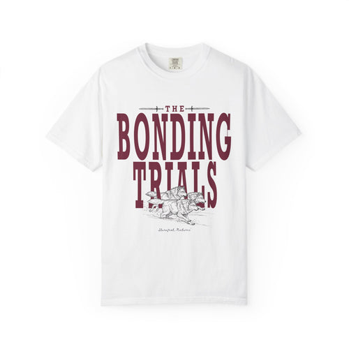 A white Comfort Colors unisex graphic tee from thtgrlreads featuring a vintage wash print with "The Bonding Trials" text and a detailed line art wolf design, part of the Wolves of Ruin collection.